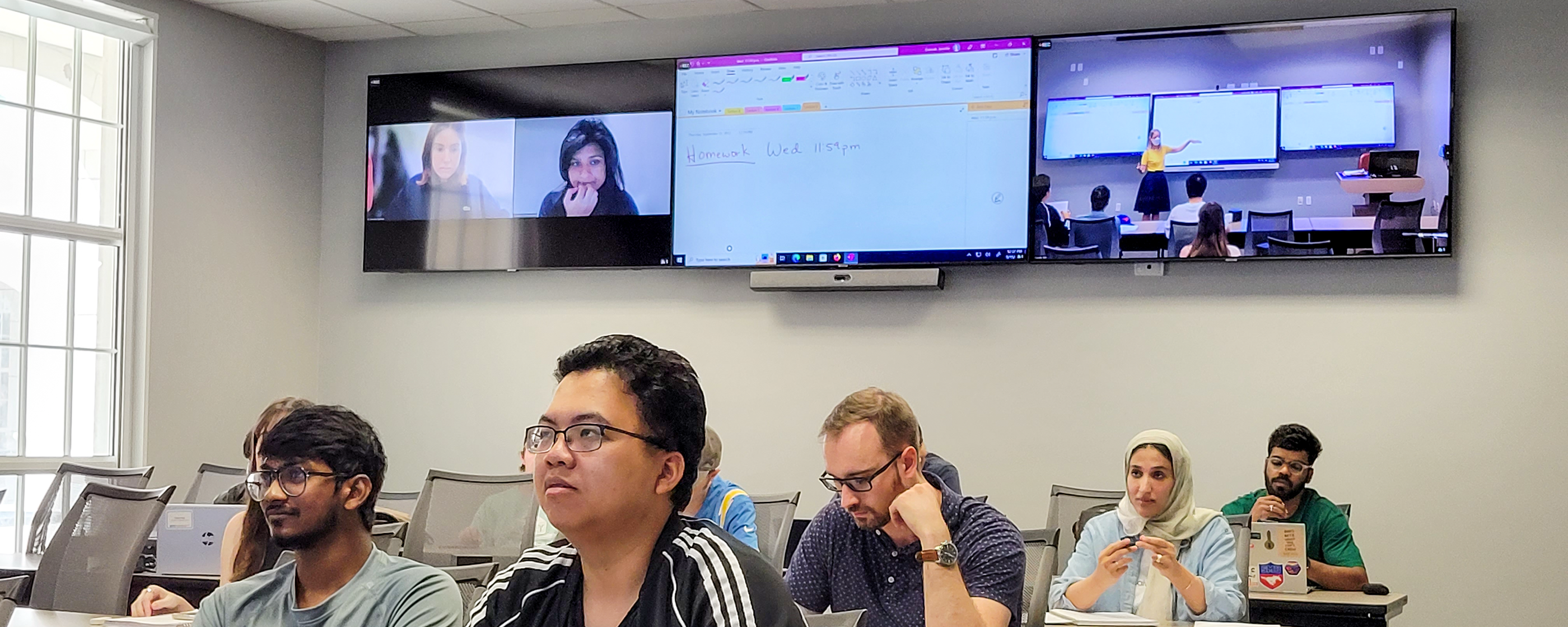 Students attending classes in person and online classes through zoom meeting.