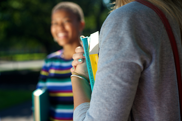Student with striped shirt and book.