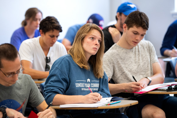 girl in class taking notes