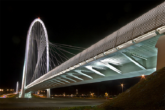 Illuminated modern cable-stayed bridge representing advanced structural engineering