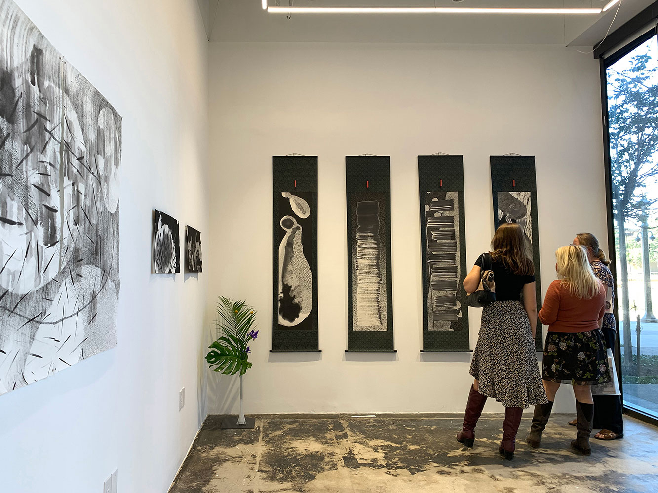 Patrons view "KuroKuroShiro – The Four Seasons," a piece by art professor Nishiki Sugawara-Beda.