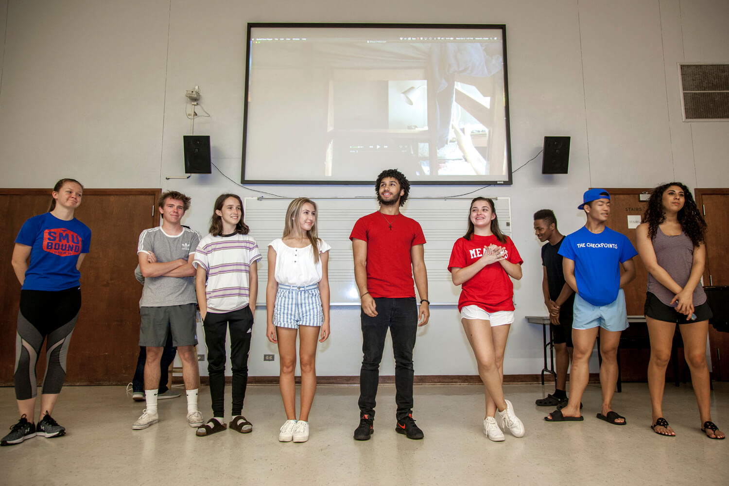 Students Standing In A Line Facing classmates