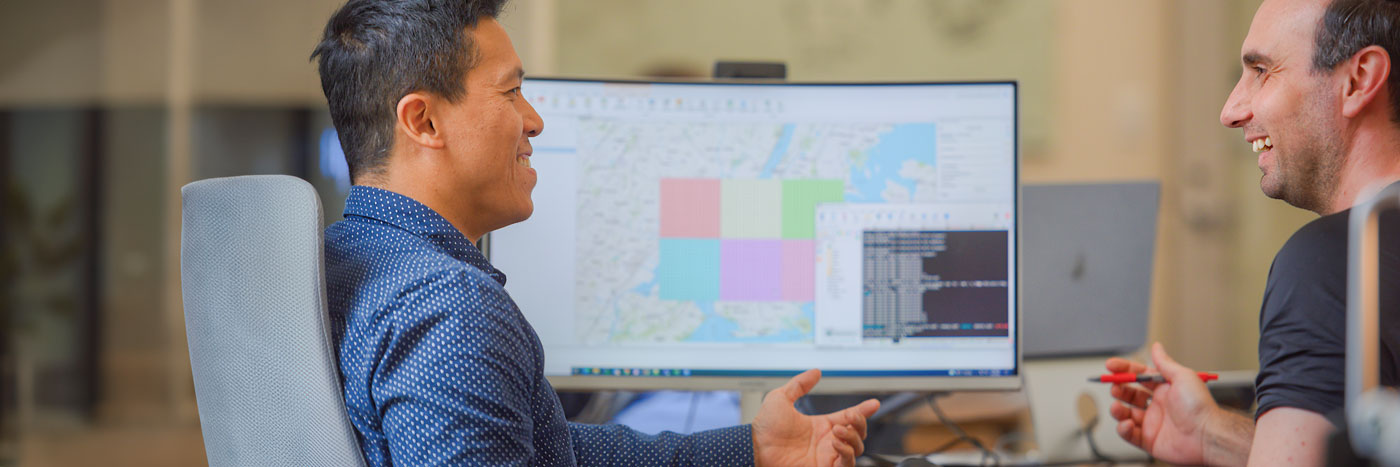 AI and Machine Learning Research Engineer Tue Vu, Ph.D. discusses a project with a faculty member.