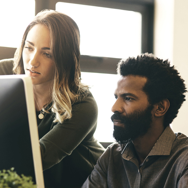 Woman and man working on a computer