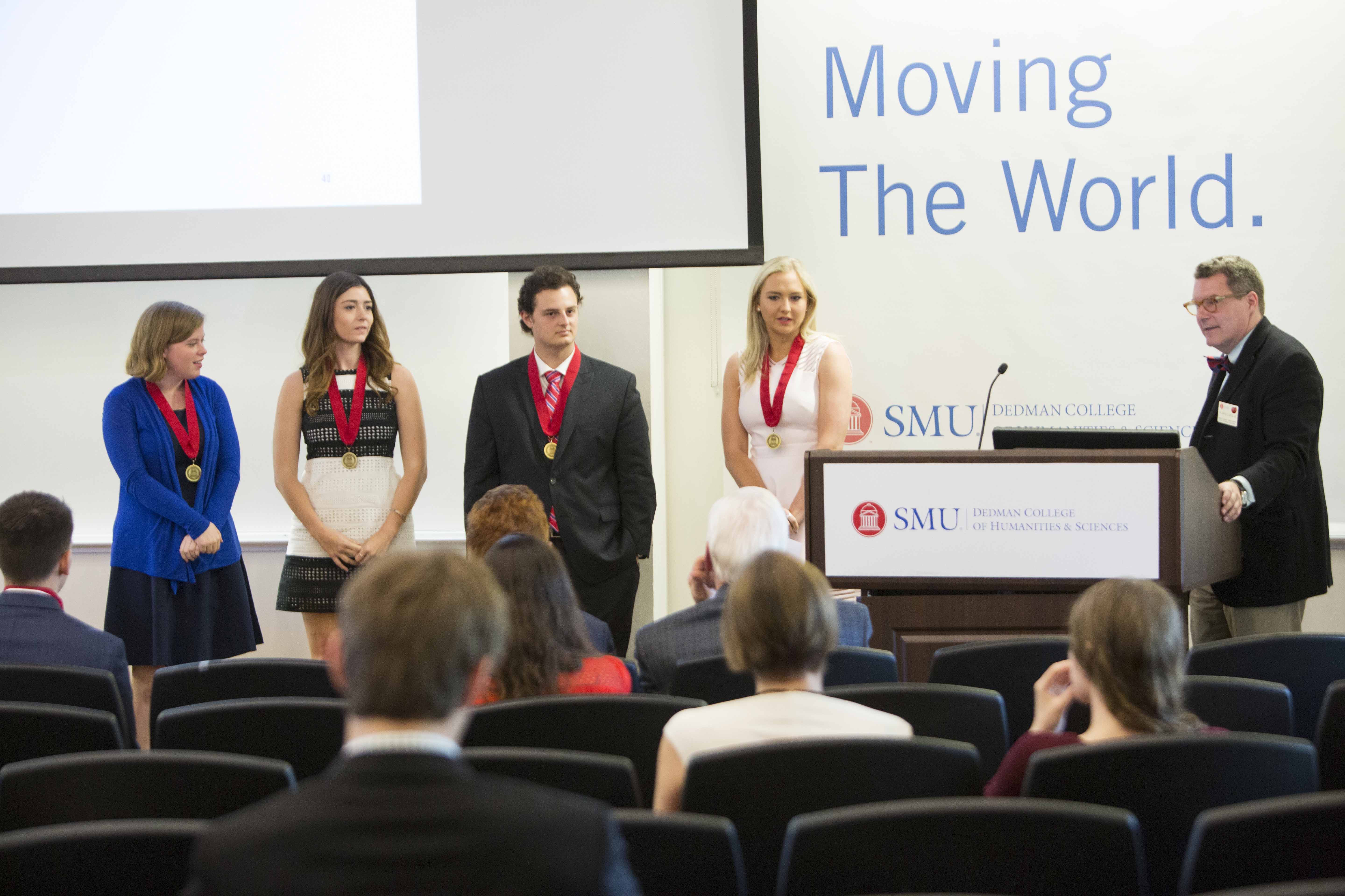 Four students receive recognition and a medal from Dr. David D. Doyle