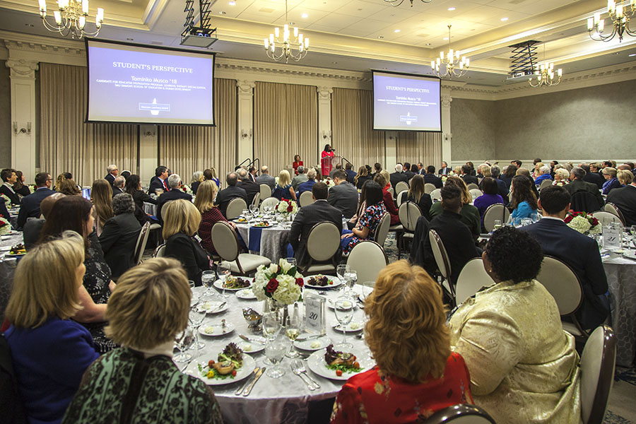 A crowded room with people seated at tables, celebrating the 2019 Simmons Luminary Award recipients.