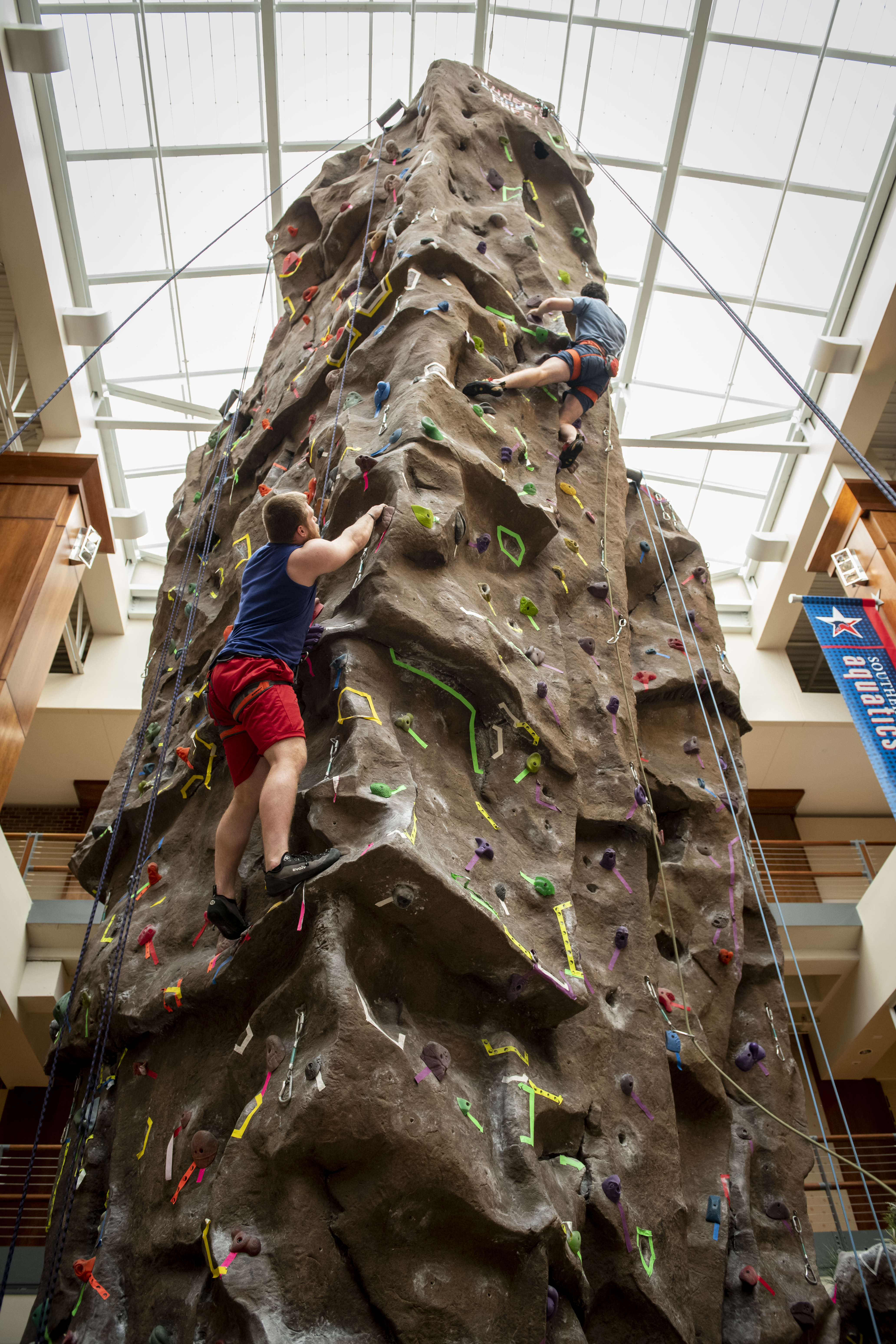 person climbing on indoor climbing wall